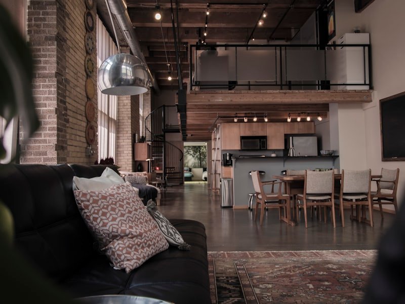 Vancouver loft with industrial brick, dark fireplace surround and steel staircase