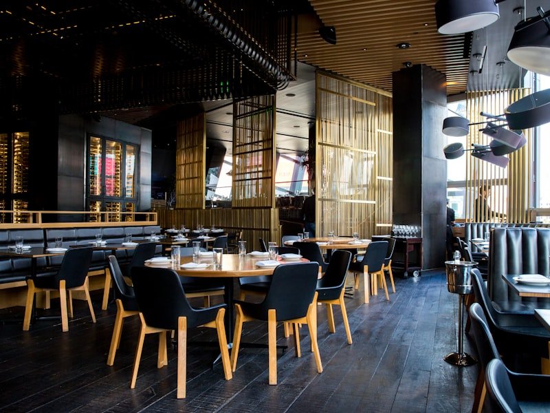 Vancouver restaurant interior with stone surfaces and warm wood ceiling